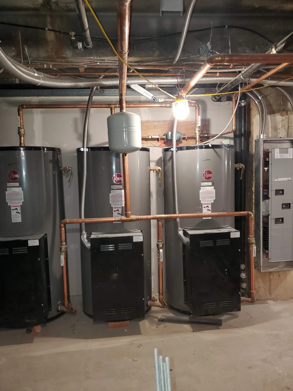 Multiple commercial water heater units in a mechanical room